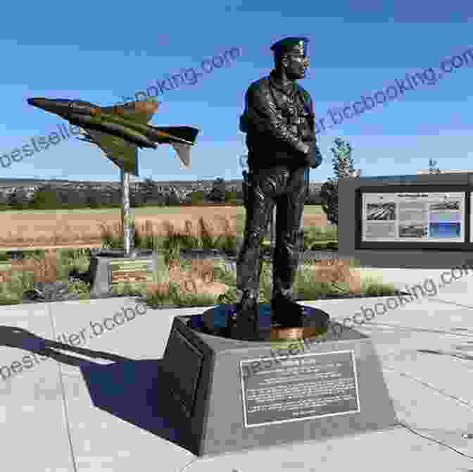 A Monument Honoring Robin Olds, Featuring A Bronze Statue Of Him In A Flight Suit, Surrounded By Flowers. In The Cockpit With Robin Olds (Passion For Flight 7)