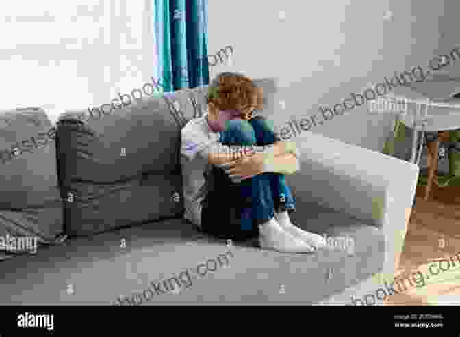 A Young Boy On The Autism Spectrum Sitting Alone In A Room, Looking Sad. How People With Autism Grieve And How To Help: An Insider Handbook